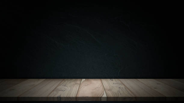 istock Wooden tabletop and dark plaster wall background. 1316585453