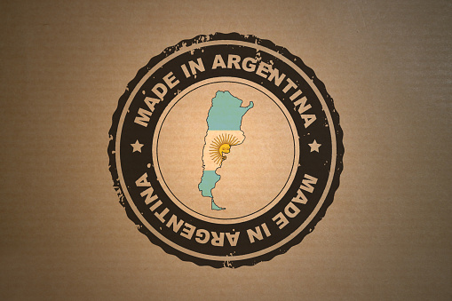 Brown paper with in its middle a retro style stamp Made in Argentina include the map and flag of Argentina.