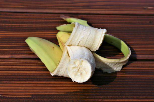 istock peeled banana on a wooden table 1316586908