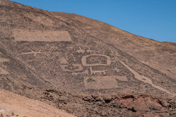 istock Numerous designs (geoglyphs) created in the rocks and sand are easily visible in these rolling, desert hills in the Pampa del Tamarugal National Reserve 1316588490