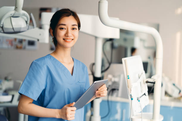 istock Asian dentist using digital tablet in clinic. 1316588517