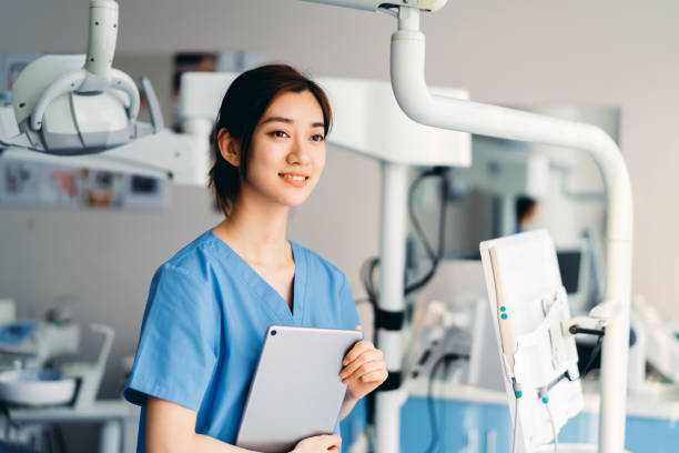 istock Asian dentist using digital tablet in clinic. 1316588586
