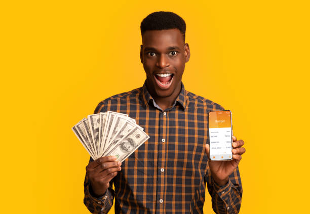 istock Emotional black man gambling online, showing prize 1316589128