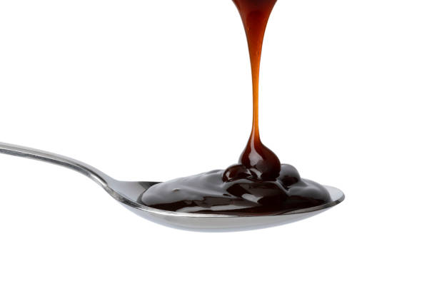 istock Spoon with thick brown oyster sauce close up 1316590288