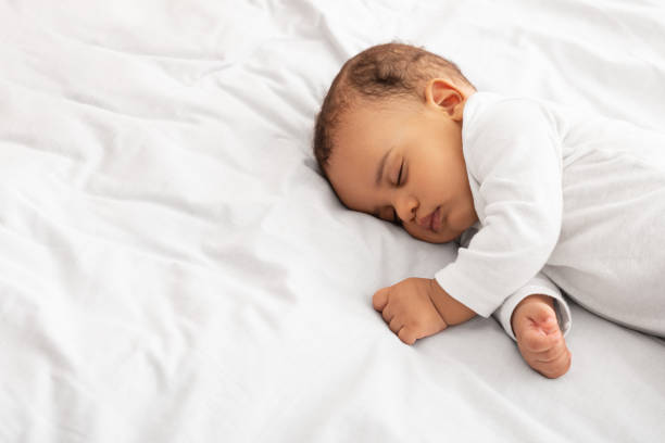 istock Little Baby Boy Sleeping Peacefully Lying In Bed Indoors 1316590330