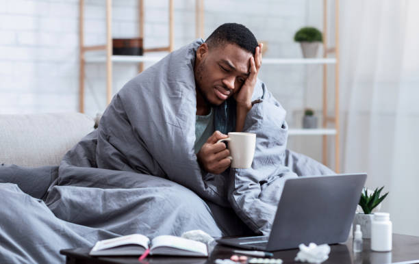 istock Sick African Man Using Laptop Having Fever And Headache Indoor 1316590975