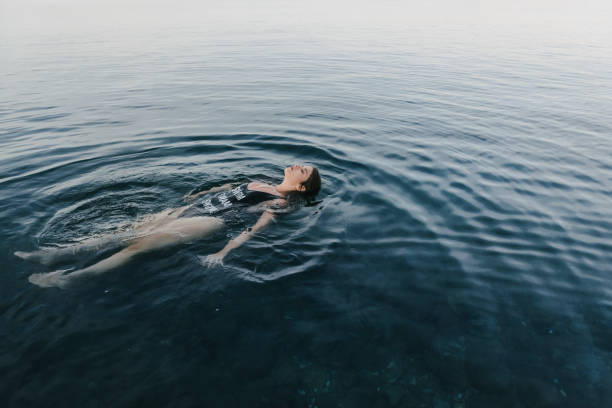 istock Woman relaxing on her back in a sea water 1316593471