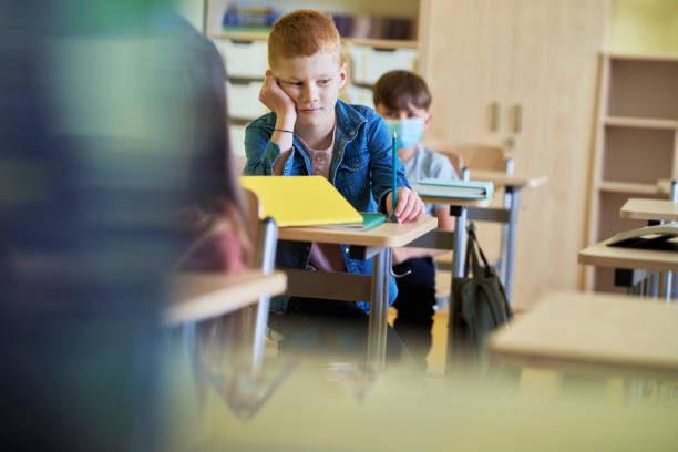 istock One schoolboy no mask in school during a pandemic 1316594676