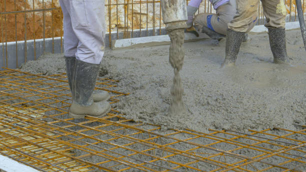 istock CLOSE UP: Contractors pour wet mortar over wiring while building the foundation 1316596592