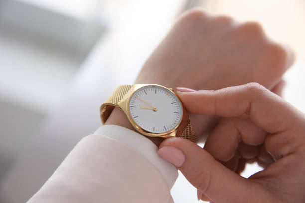 istock Woman with luxury wristwatch on blurred background, closeup 1316599105