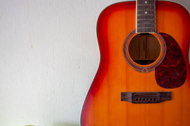 istock An acoustic guitar on a white background 1316601468