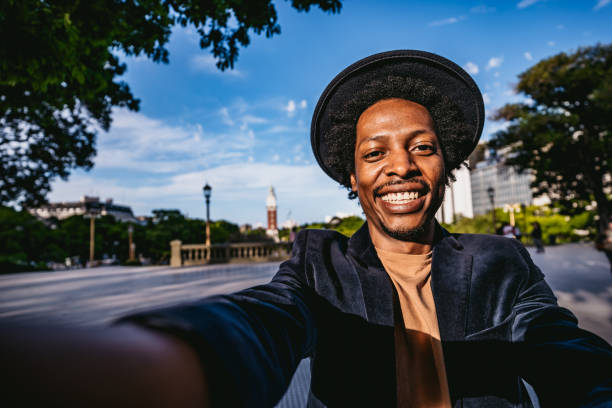 istock Smiling man making selfie in park 1316601516