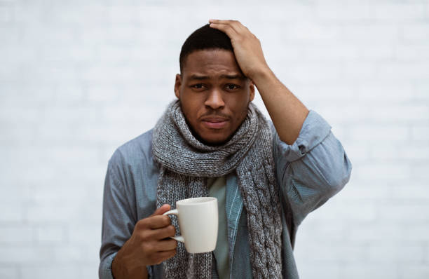 istock African Man Having Headache And Fever Standing Over White Wall 1316601736