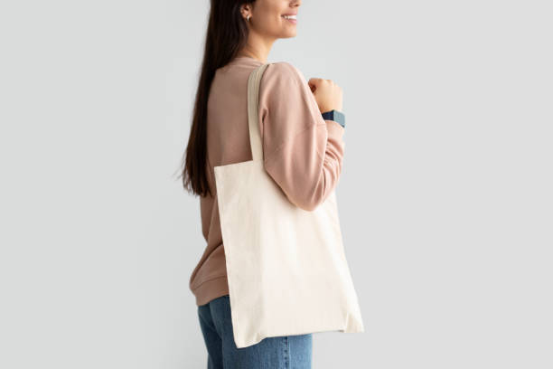 istock Young woman standing with blank canvas tote bag 1316602449