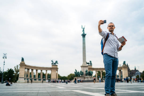 istock Young male tourist making selfie on Heroes Square 1316602572