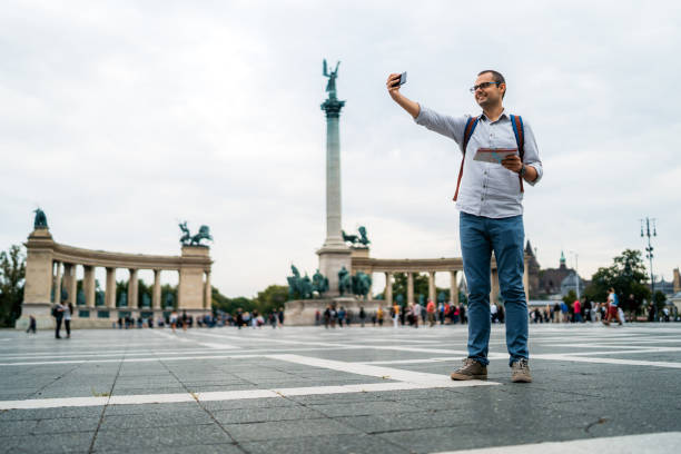 istock Young male tourist making selfie on Heroes Square 1316602610
