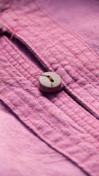 istock Wooden button in purple linen shirt 1316602788