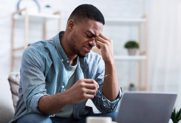 istock African Man Massaging Nosebridge Tired After Work On Computer Indoors 1316602876