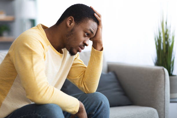 istock Thoughtful african american man touching his head, home interior 1316604321