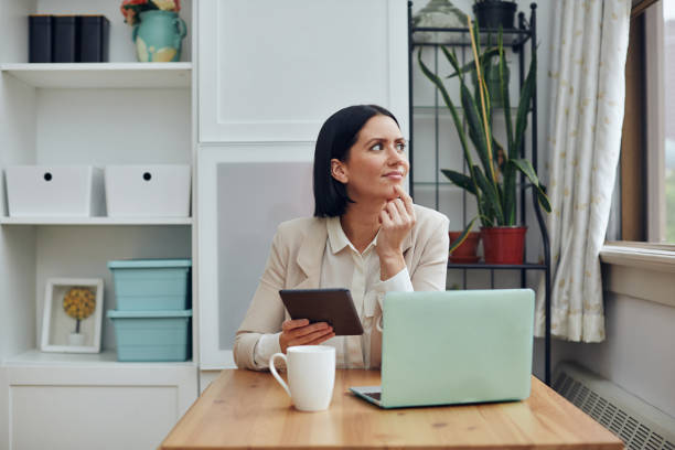 istock young woman using laptop and looking at camera while sitting in cafe 1316605675