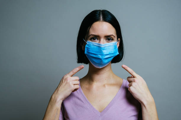 istock woman with protective mask on grey background 1316605707