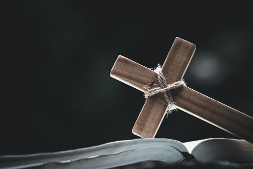 Closeup of  wooden christian cross  on Bible,  god, Wooden cross of Jesus.