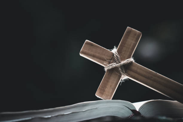 closeup of  wooden christian cross  on bible,  god, wooden cross of jesus. - color image jesus christ child people imagens e fotografias de stock