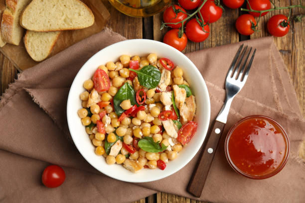 istock Delicious fresh chickpea salad served on wooden table 1316609376
