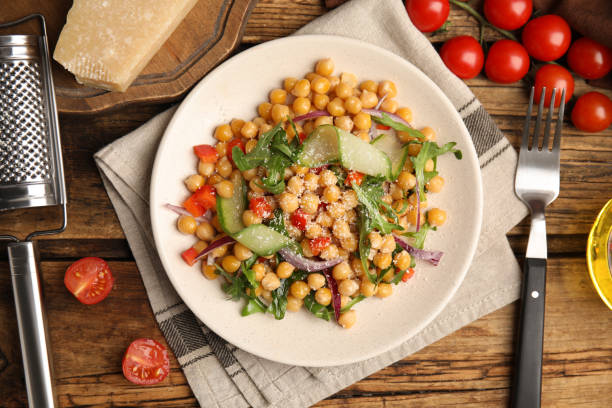 istock Delicious fresh chickpea salad served on wooden table, flat lay 1316609405