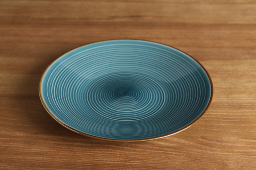 Elegant new empty plate on wooden table