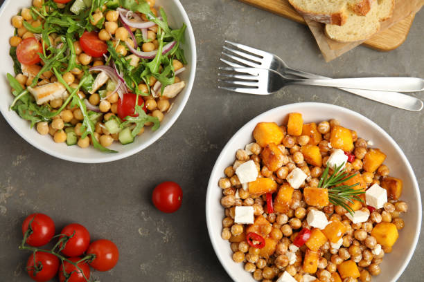 istock Delicious fresh chickpea salads on grey table, flat lay 1316609679