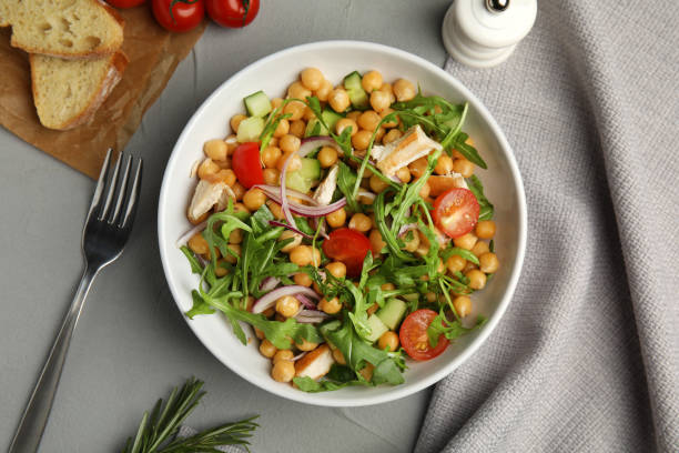 istock Delicious fresh chickpea salad served on light grey table, flat lay 1316610670