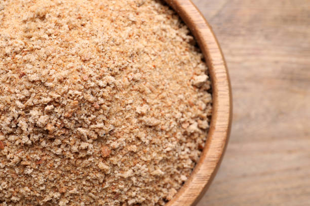 istock Fresh breadcrumbs in bowl on wooden table, top view 1316611006