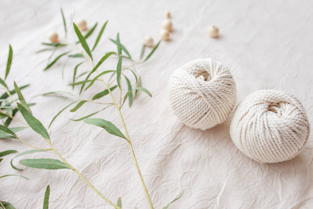 istock Handmade macrame braiding and cotton threads. Image good for macrame and handicrafts banners and advertisement.  Top view. Copy space 1316614376