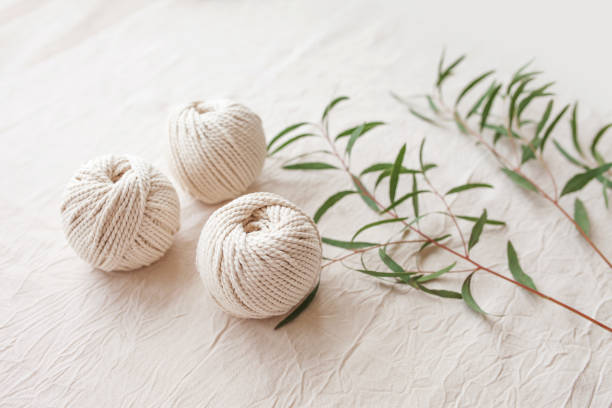 istock Handmade macrame braiding and cotton threads. Image good for macrame and handicrafts banners and advertisement.  Top view. Copy space 1316614383