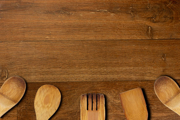 istock Topview of a rustic wooden table with wooden spoon and fork -background 1316615522