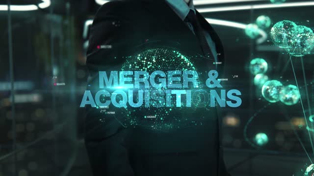Businessman with Merger & Acquisitions hologram concept