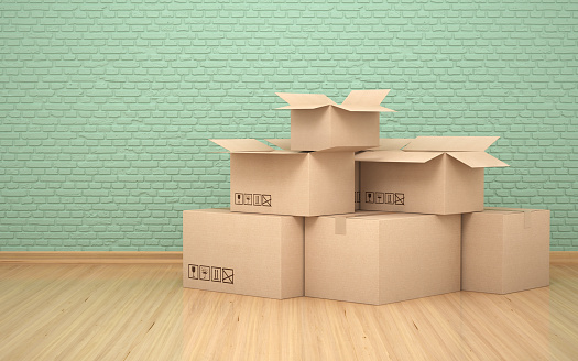 3d render Cardboard boxes in front of a green colored stone wall,time to move to a new house (close-up)
