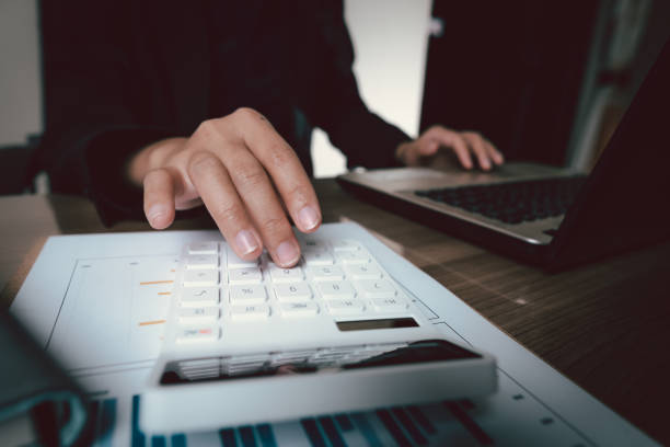 istock bookkeeper or financial inspector hands making report, calculating or checking balance. Home finances, investment, economy, saving money or insurance concept 1316621767