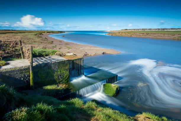 River Keer Estuary, Carnforth, Morecambe Bay.\nPolluted sewerage works outflow into River Keer, Morecambe Bay.  Long exposure.