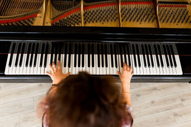 istock Woman playing on a piano 1316623565