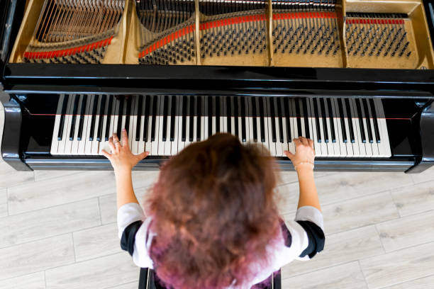 istock Woman playing on a piano 1316623654