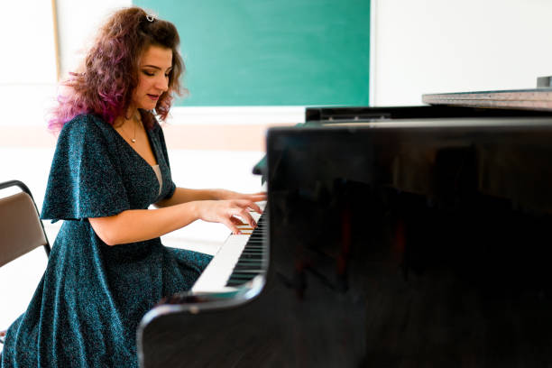 istock Woman playing on a piano 1316623660