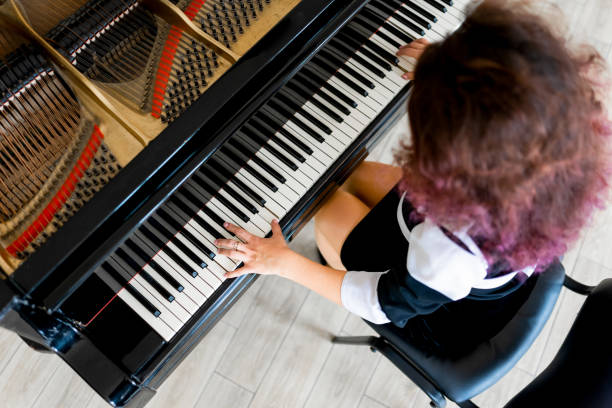 istock Woman playing on a piano 1316623723