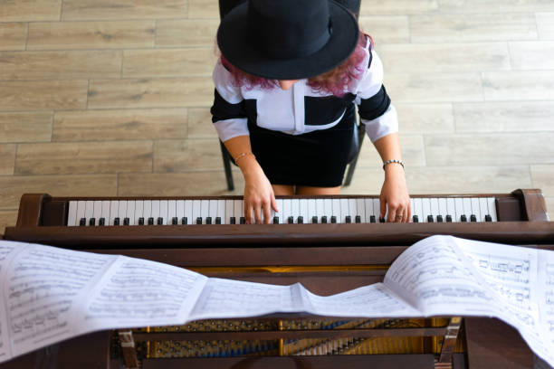 istock Woman playing on a piano 1316623802