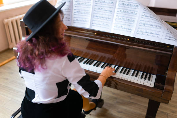 istock Woman playing on a piano 1316623841