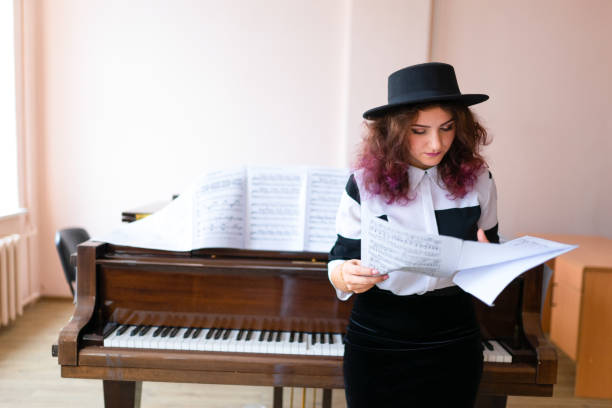 istock Woman playing on a piano 1316623896