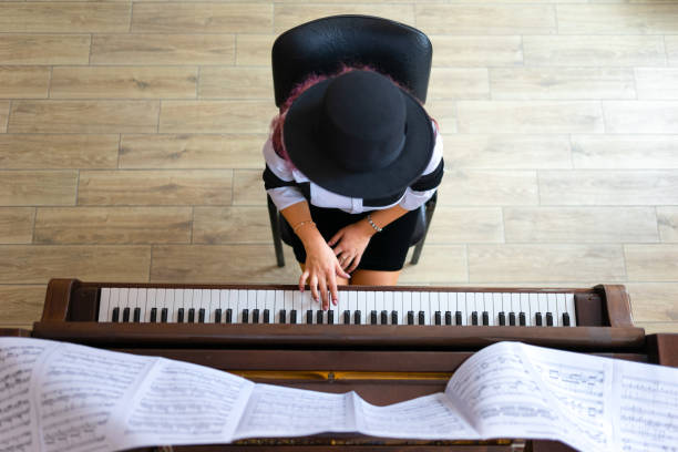 istock Woman playing on a piano 1316624230