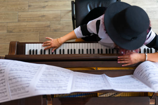 istock Woman playing on a piano 1316624395