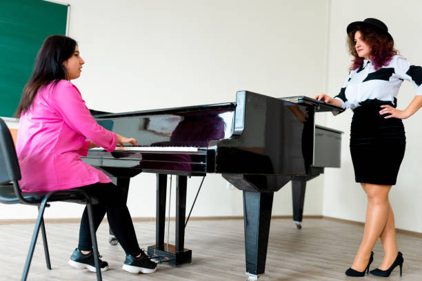 istock Woman playing on a piano 1316624681